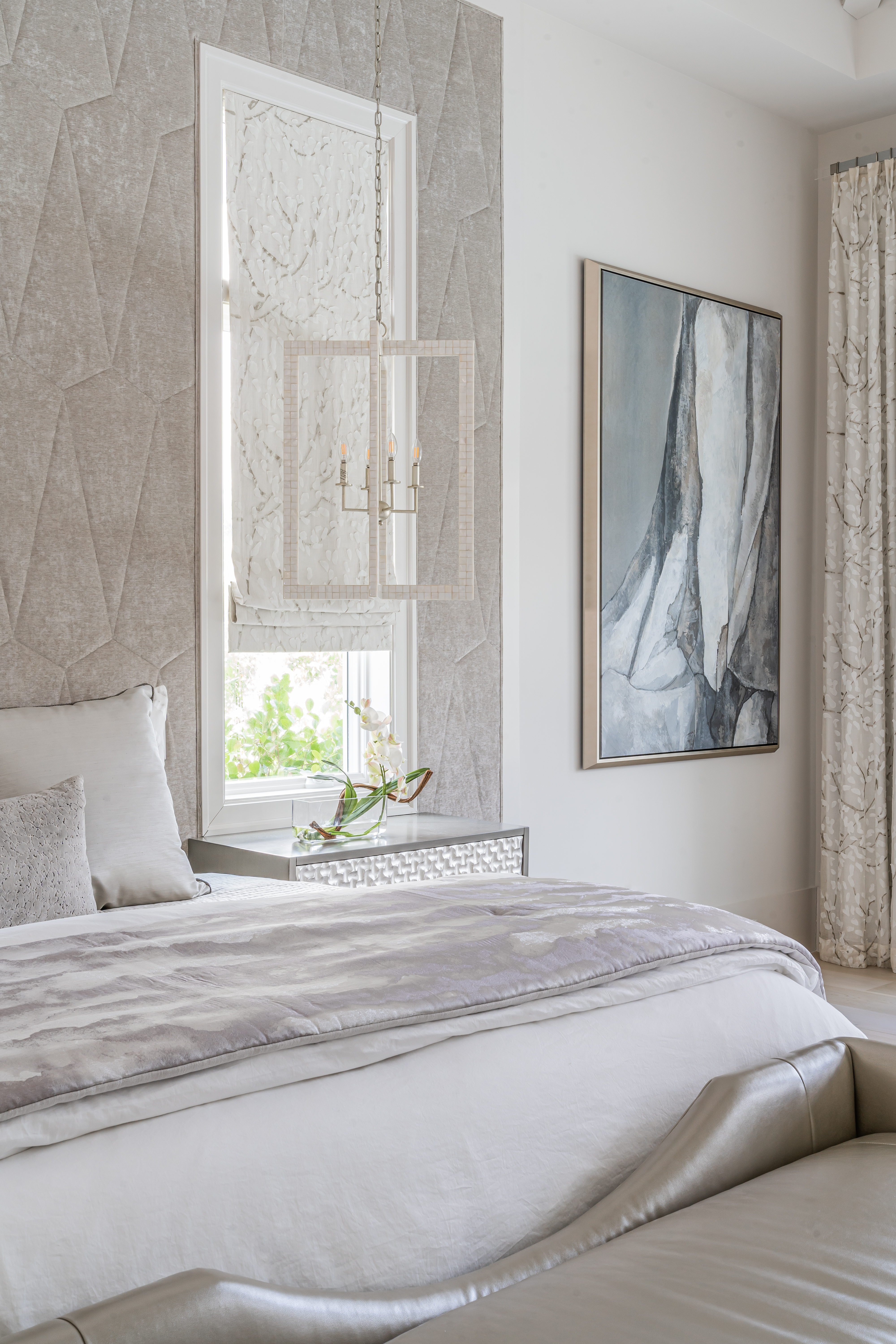 A coastal contemporary primary bedroom design with a neutral palette, designed by Florida interior designer Brooke Meyer of Gulfshore Interior Design