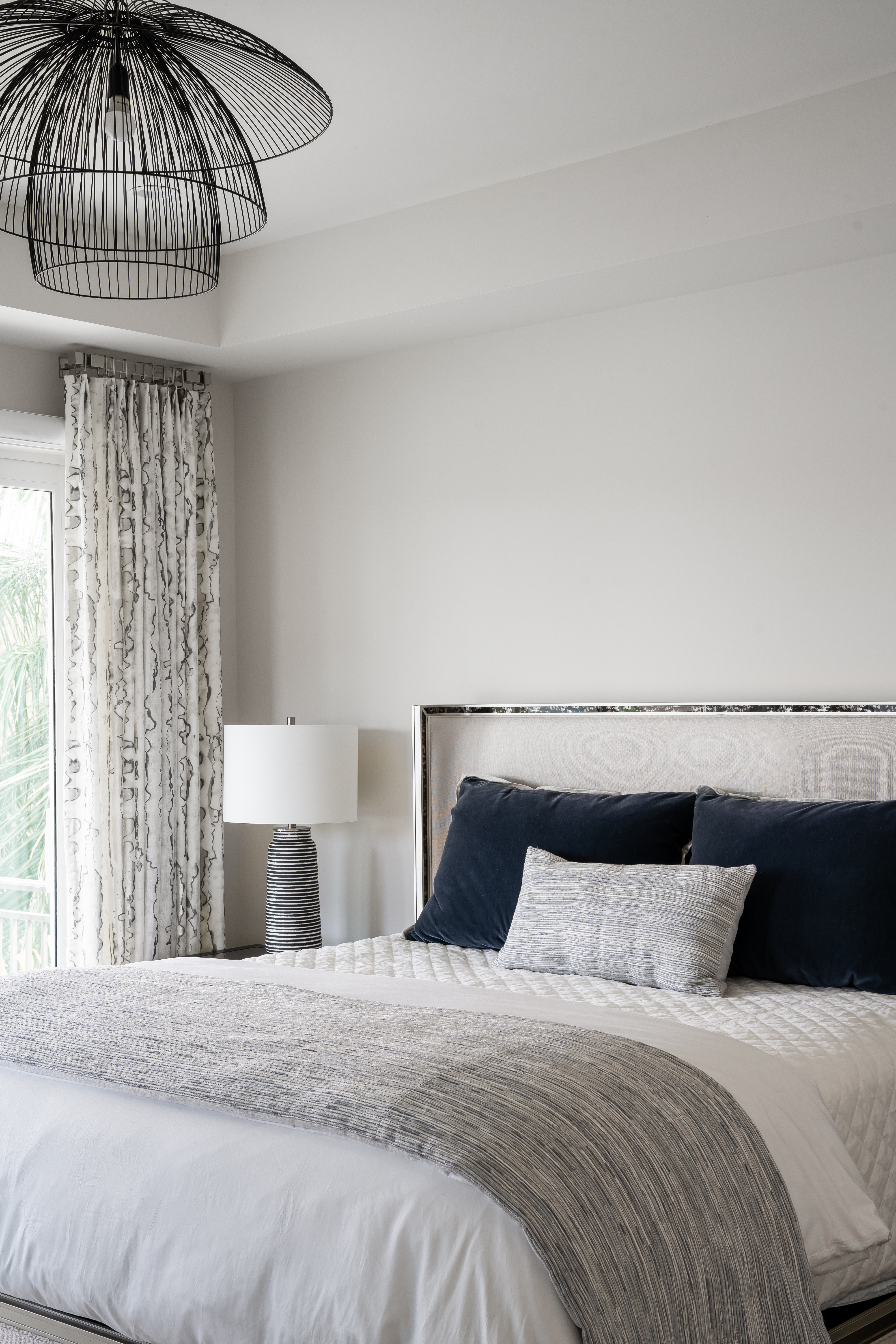 A coastal contemporary guest bedroom design with a neutral palette, designed by Florida interior designer Brooke Meyer of Gulfshore Interior Design
