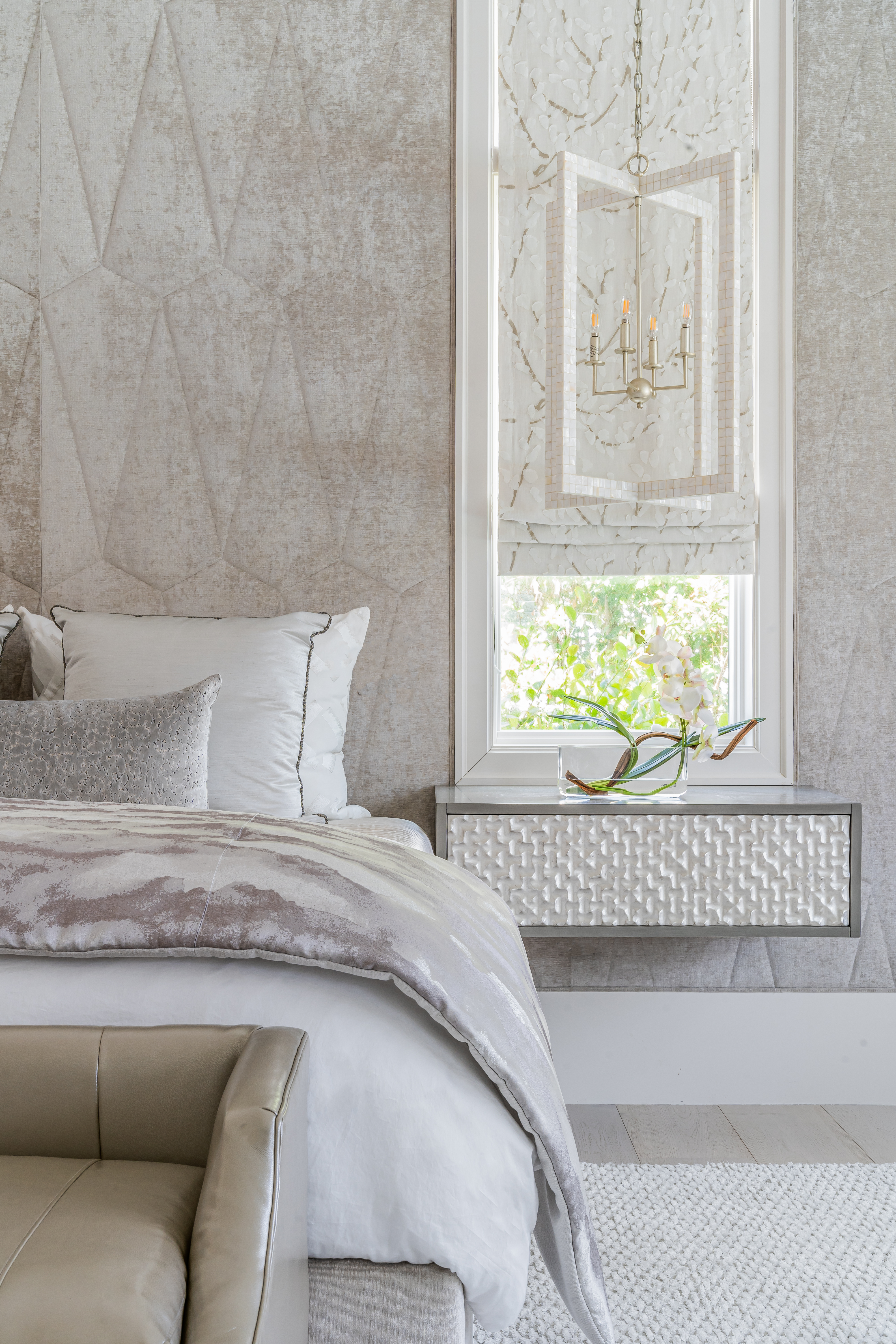 A coastal contemporary primary bedroom design with a neutral palette, designed by Florida interior designer Brooke Meyer of Gulfshore Interior Design