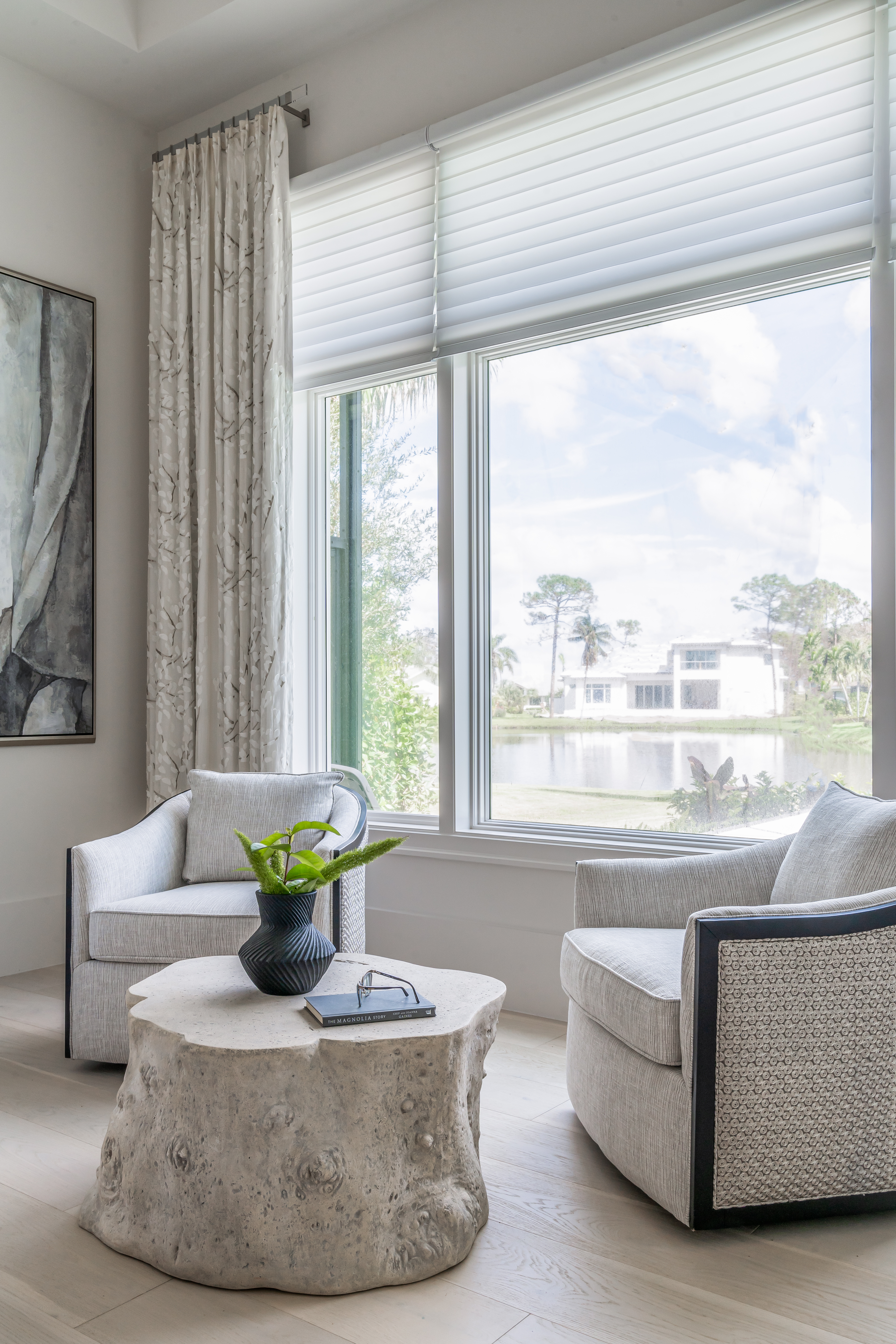 A coastal contemporary primary bedroom sitting area design with a neutral palette, designed by Florida interior designer Brooke Meyer of Gulfshore Interior Design