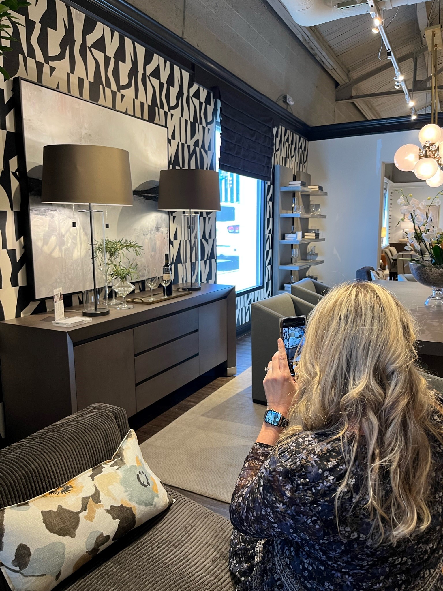 Designer Brooke Meyer captures a picture of furniture at the 2023 Spring High Point Market