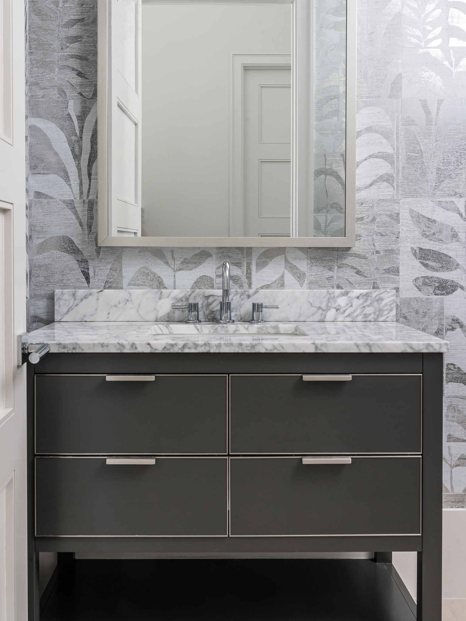 A coastal contemporary powder bathroom design with a neutral palette, designed by Florida interior designer Brooke Meyer of Gulfshore Interior Design
