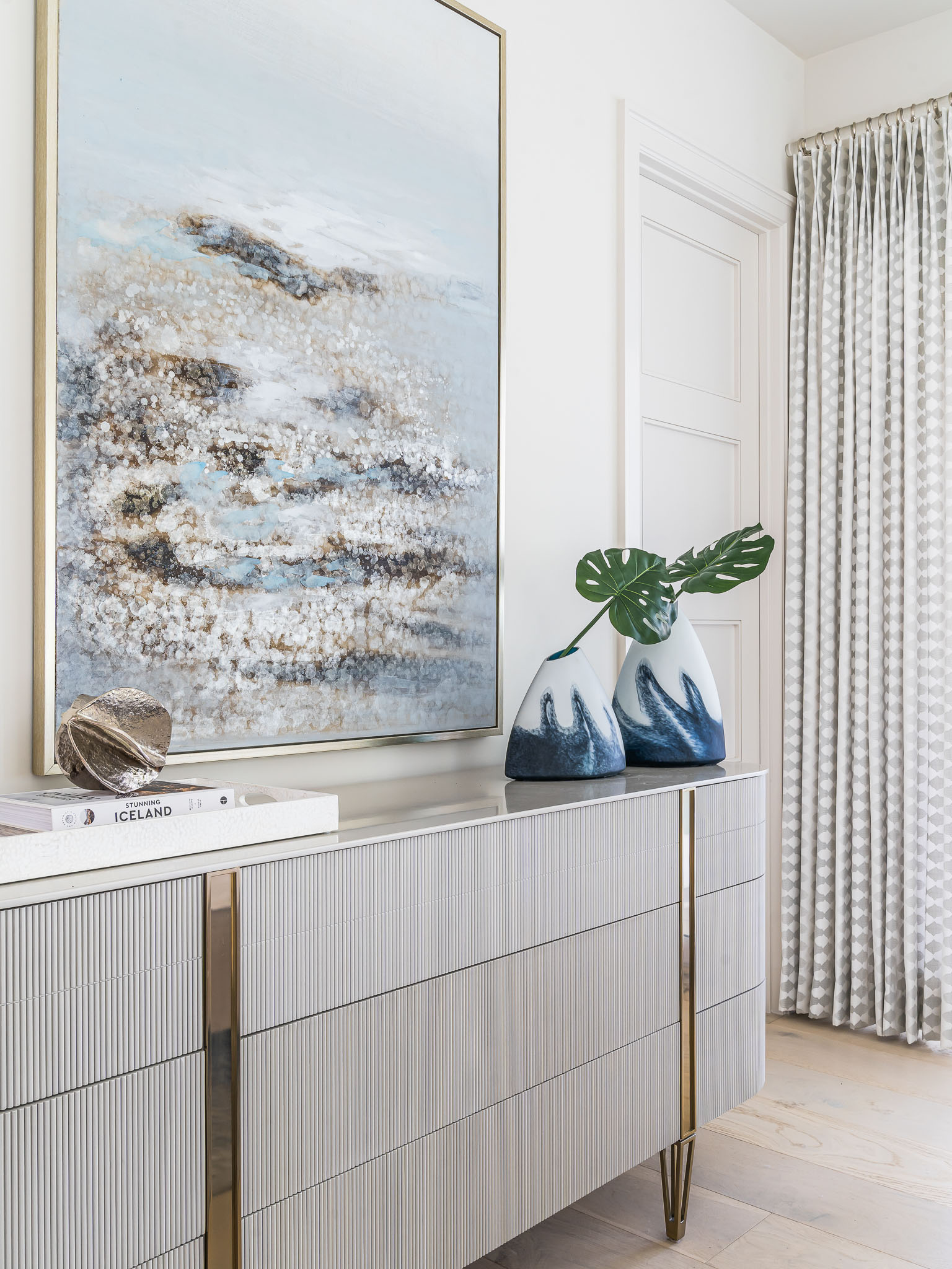 A coastal contemporary guest room with dresser, coastal wall art and accessories with a neutral palette, designed by Florida interior designer Brooke Meyer of Gulfshore Interior Design