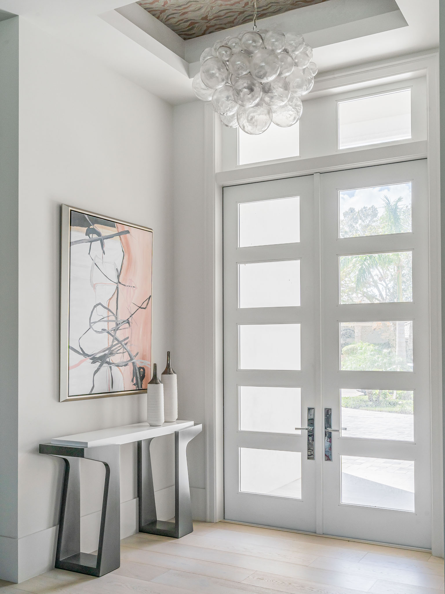 A coastal contemporary entry way design with a blush palette, designed by Florida interior designer Brooke Meyer of Gulfshore Interior Design