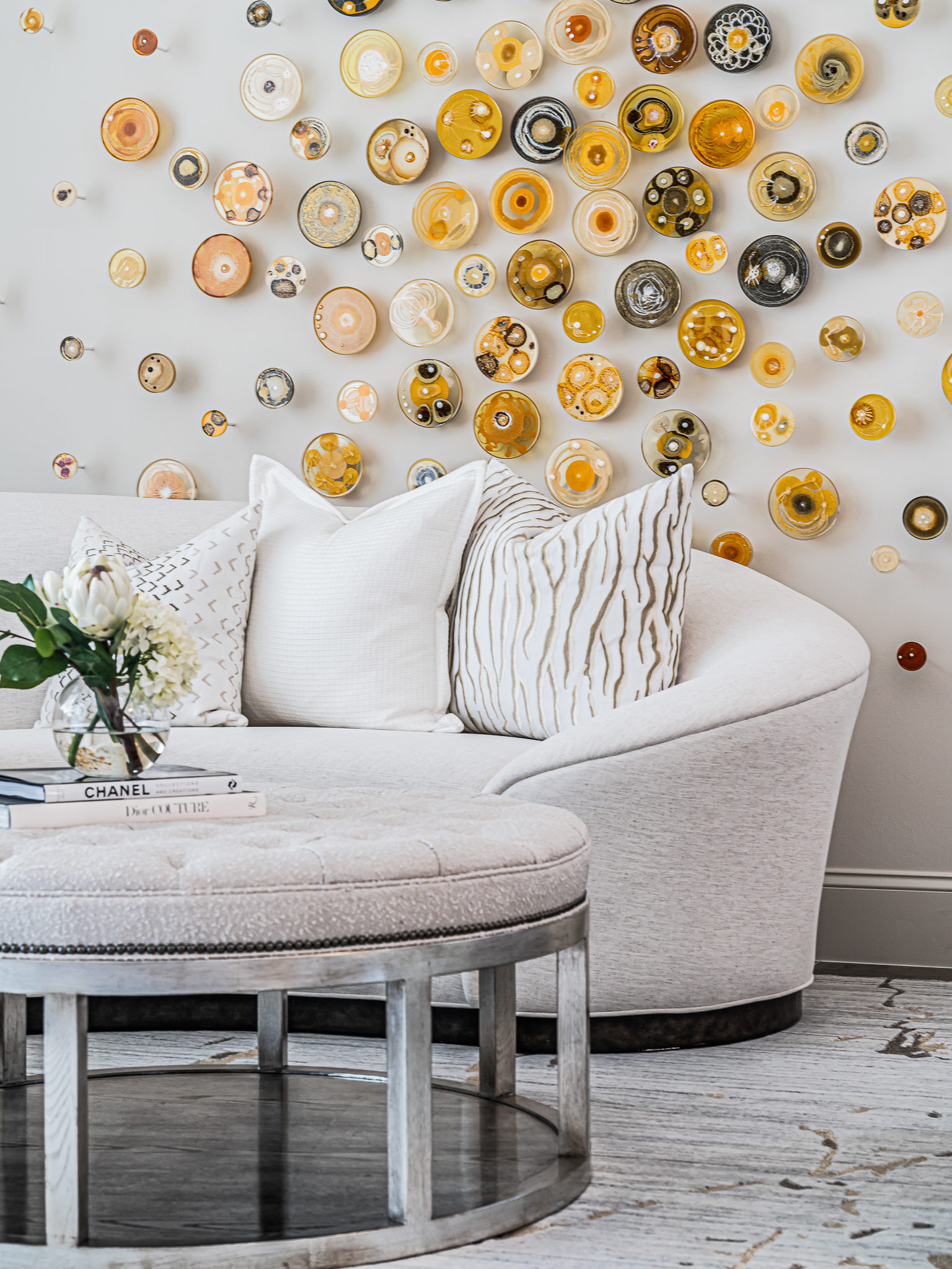 Custom fabric swivel chairs with watercolor blush and mauve pillows designed by Florida interior designer Brooke Meyer of Gulfshore Interior Design